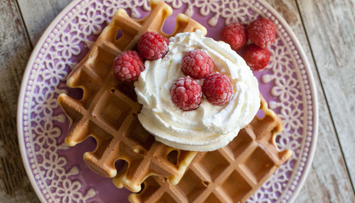 Waffles alla vaniglia con panna e lamponi